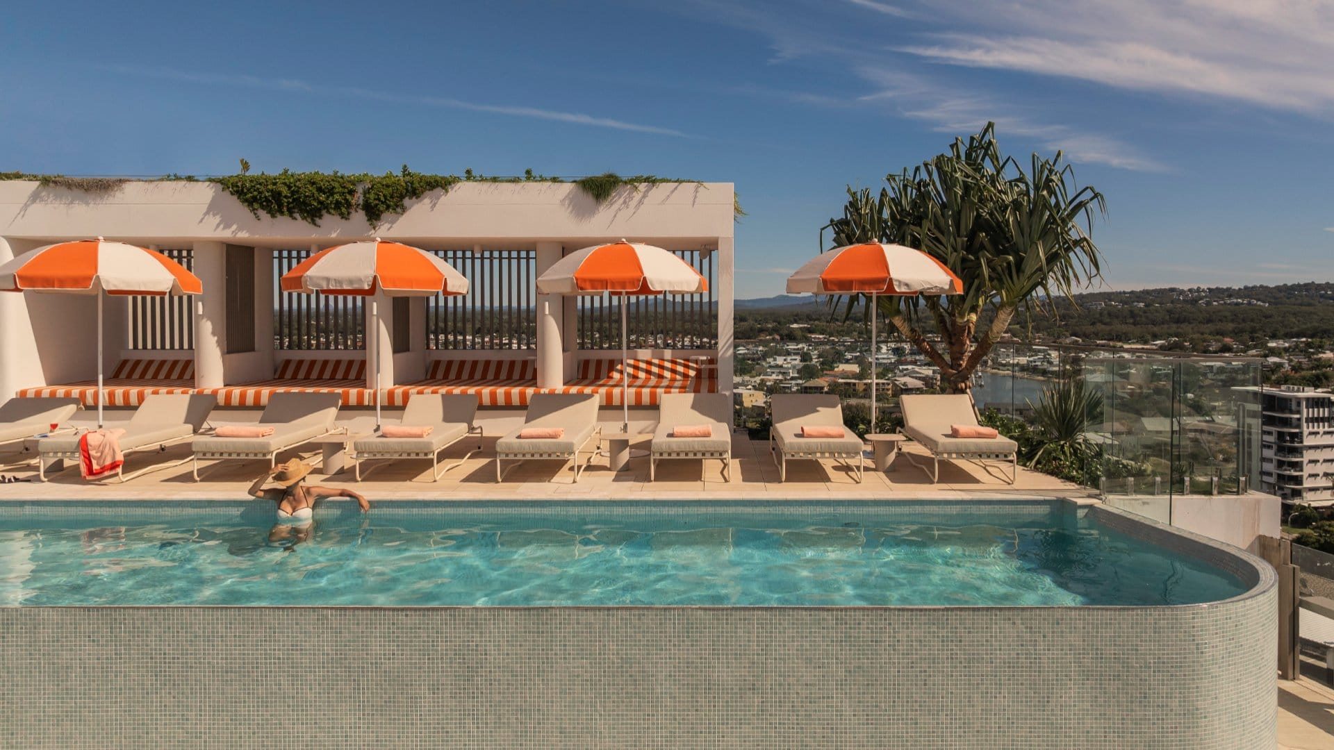 Avani_Mooloolaba_Hotel_Lady_in_Rooftop_Pool_with_Poolside_Seating_1920x1080px.jpg
